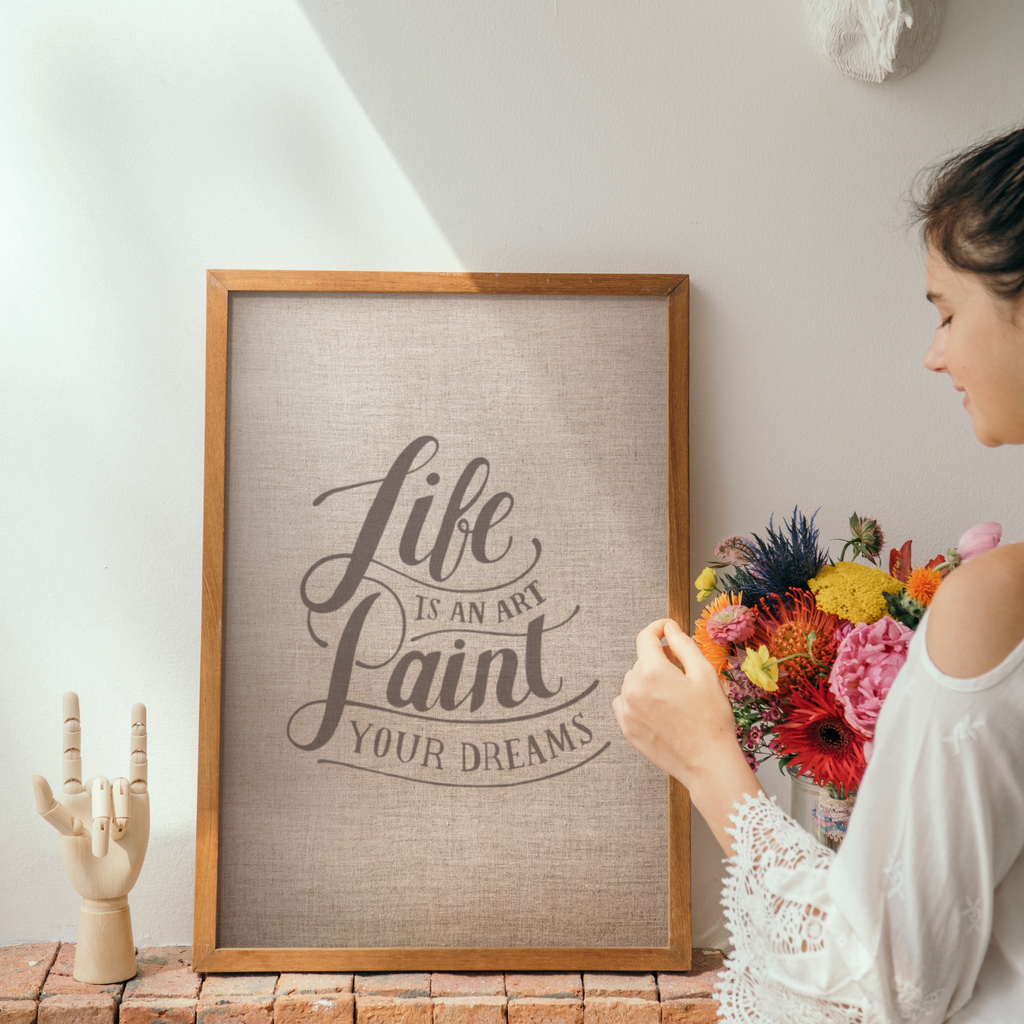 a framed wall art print with a quote saying life is beautiful paint it and next to it is a woman standing holding a bouquet of flowers