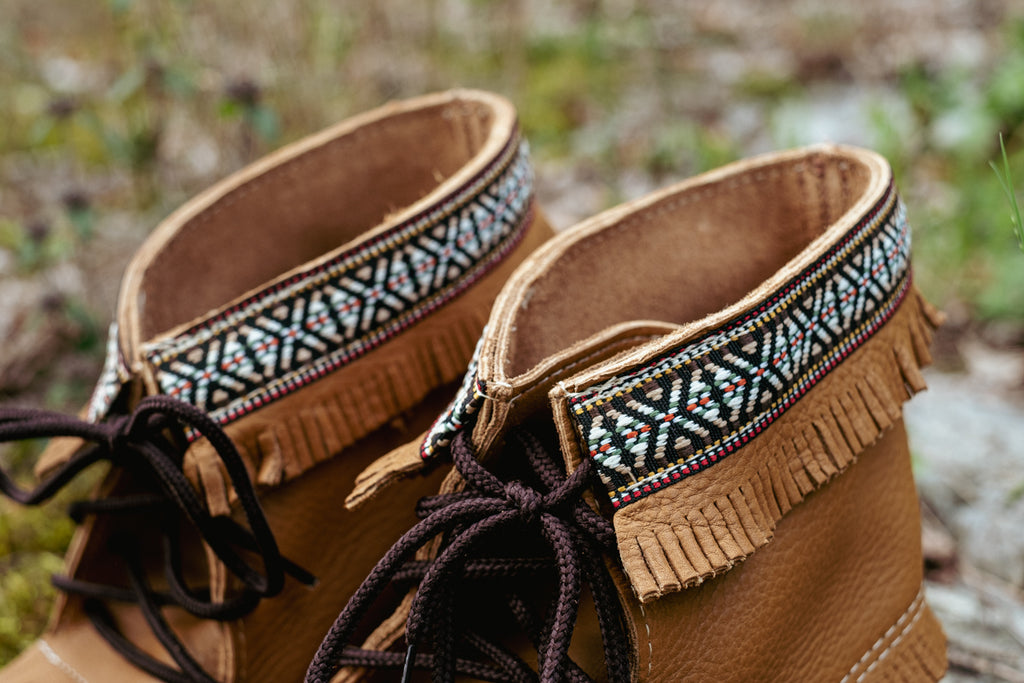 close up of indian braid pattern at the top of moccasin boots