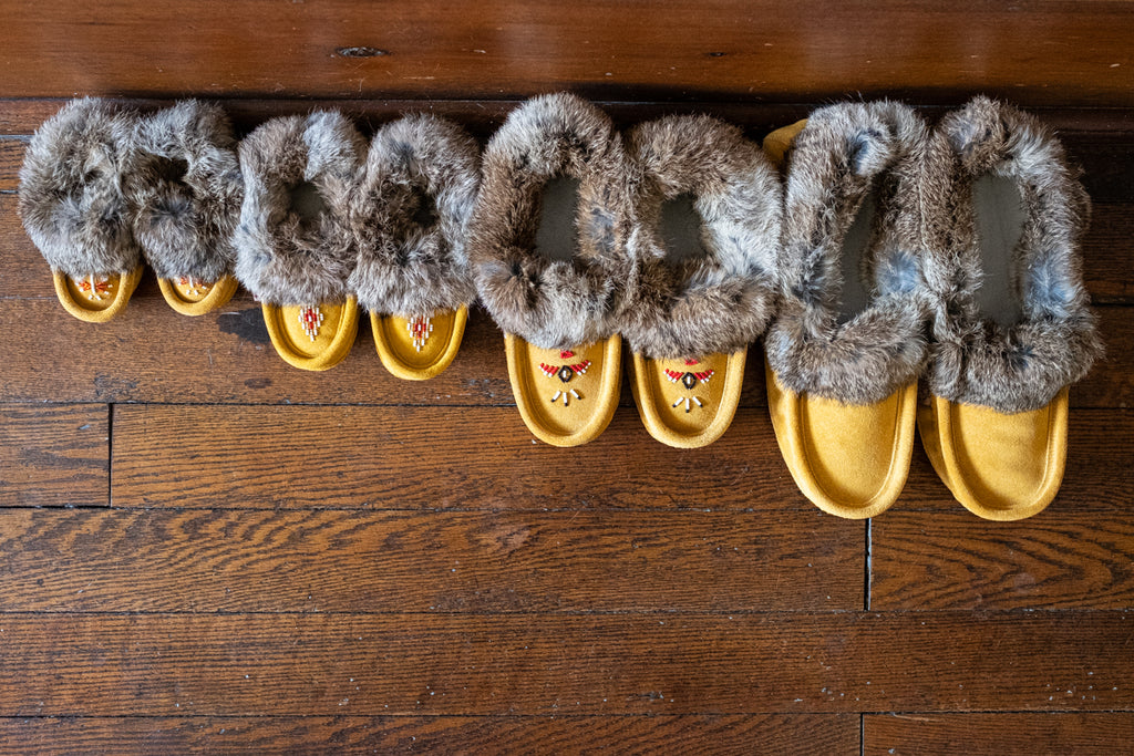 picture of moccasins for entire family side-by-side in a row