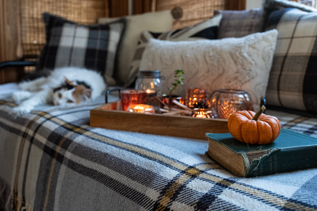 Cozy fall décor twinkling lights candles and pumpkin