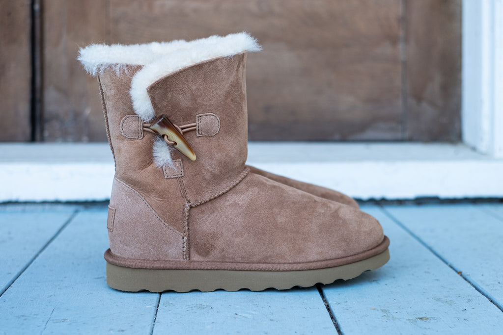 sheepskin boots with stylish antler toggle button as a side closure