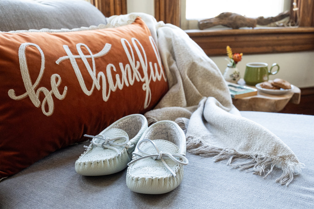 Cozy fall checklist including reading book, lighting autumn candle and drinking tea
