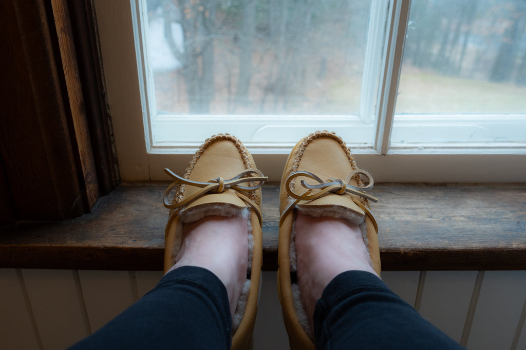 Looking out the window on a gloomy day wearing a pair of lined slippers