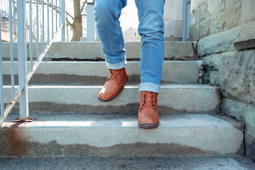 Man wearing Manitobah Mukluks Waterproof Tundra Mukluks with jeans in the city