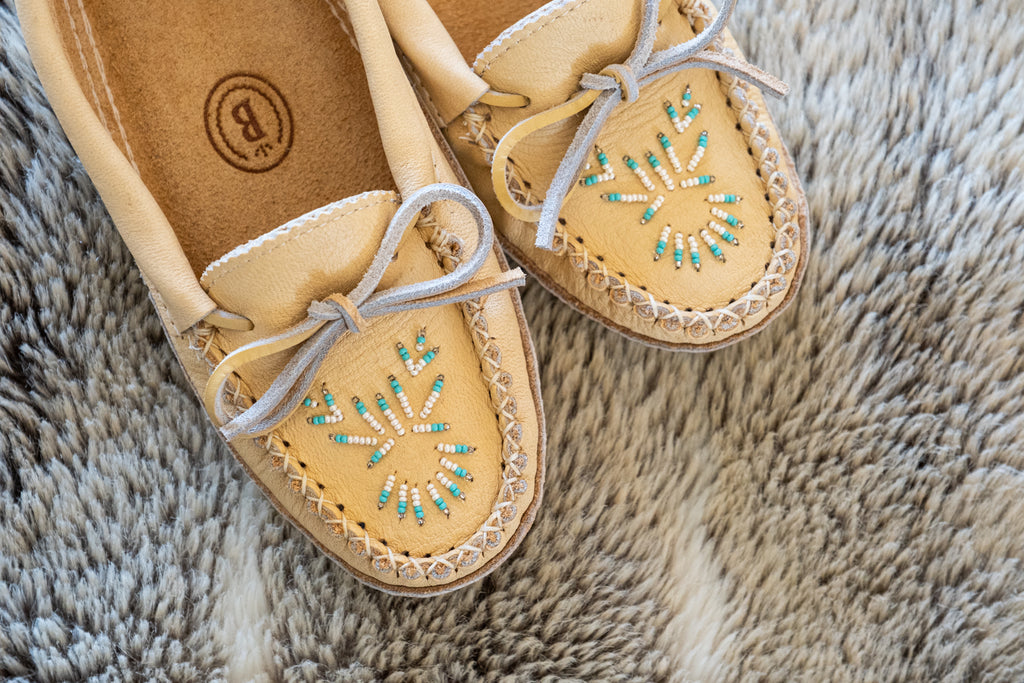 Hand- beading on a pair of authentic genuine moose hide leather moccasins made in Canada by Huron Wendat tribe Natives