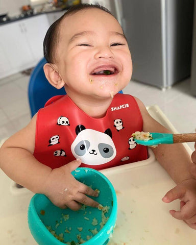 Happy Baby Eating Organic Baby Cereal