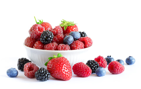 Strawberries, blueberries, blackberries that are sources for resveratrol in a bowl for skin tightening