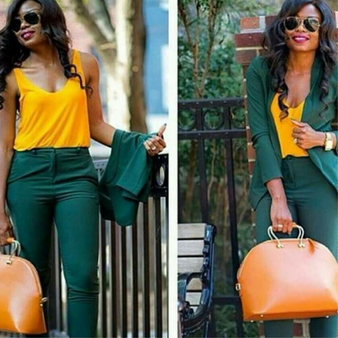 Lady wearing a yellow camisole with emerald green trousers and blazer