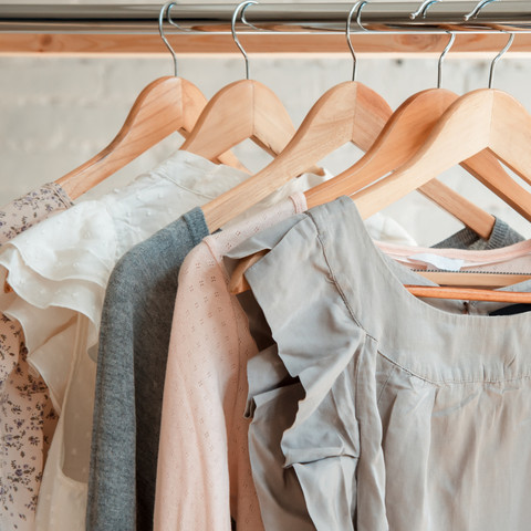 Summer clothing hanging up on wooden hangers