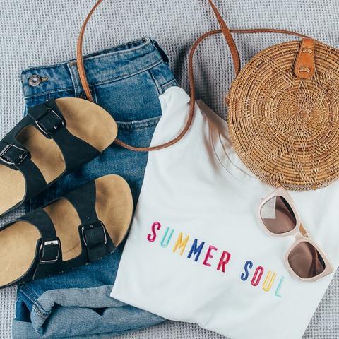 Summer shorts, summer slider sandals, summer t-shirts, sunglasses and summer handbag