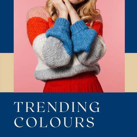 Lady holding her hands to her ears wearing a colourful knitted jersey