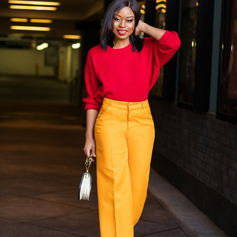 Lady with high waisted yellow trousers and red knitted sweater