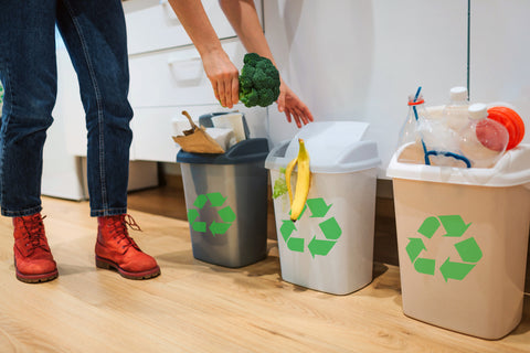 A woman sorting her recycling waste at home 