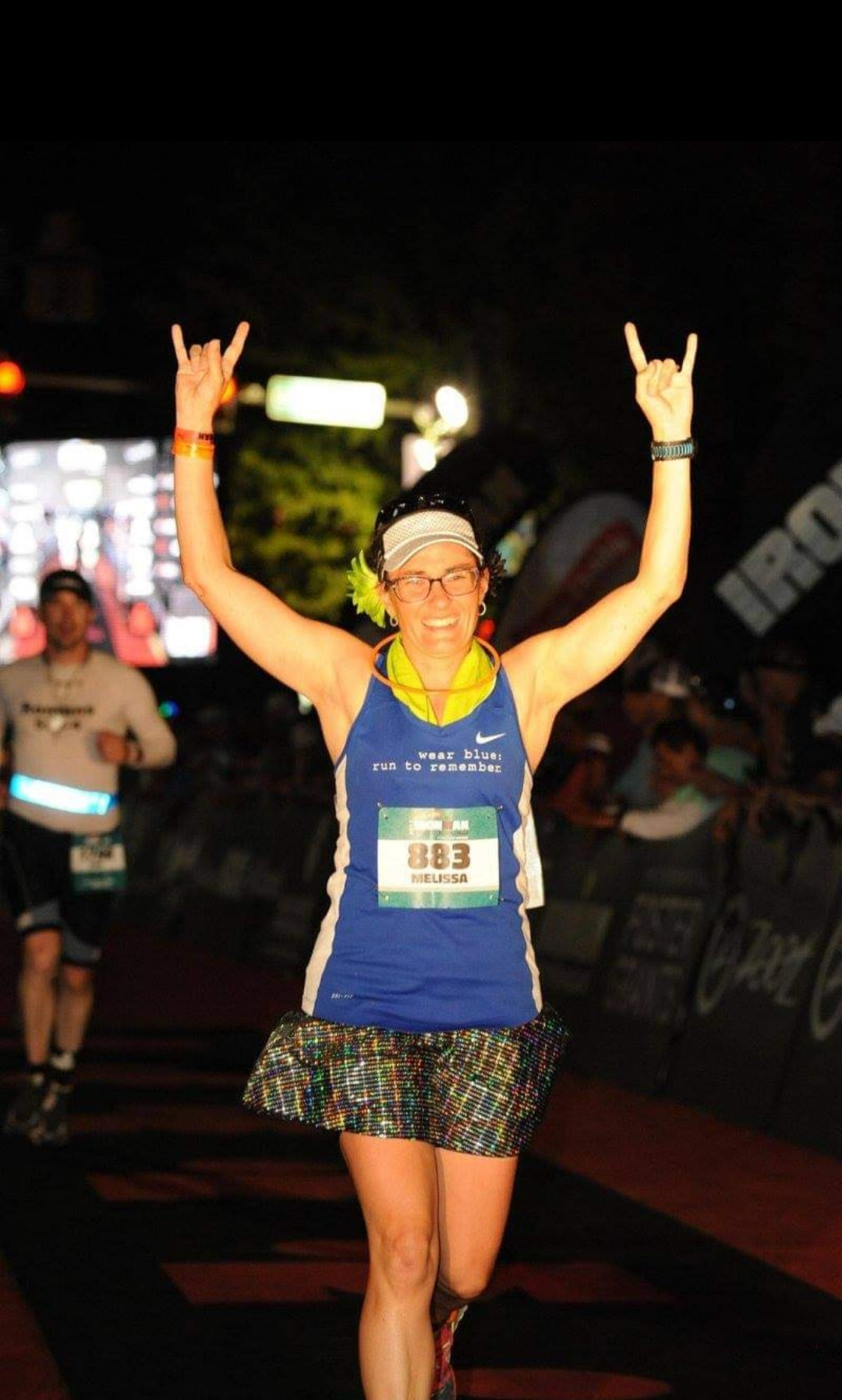 Melissa Marowelli smiling while finishing a race wearing a Bolder Athletic Wear skirt