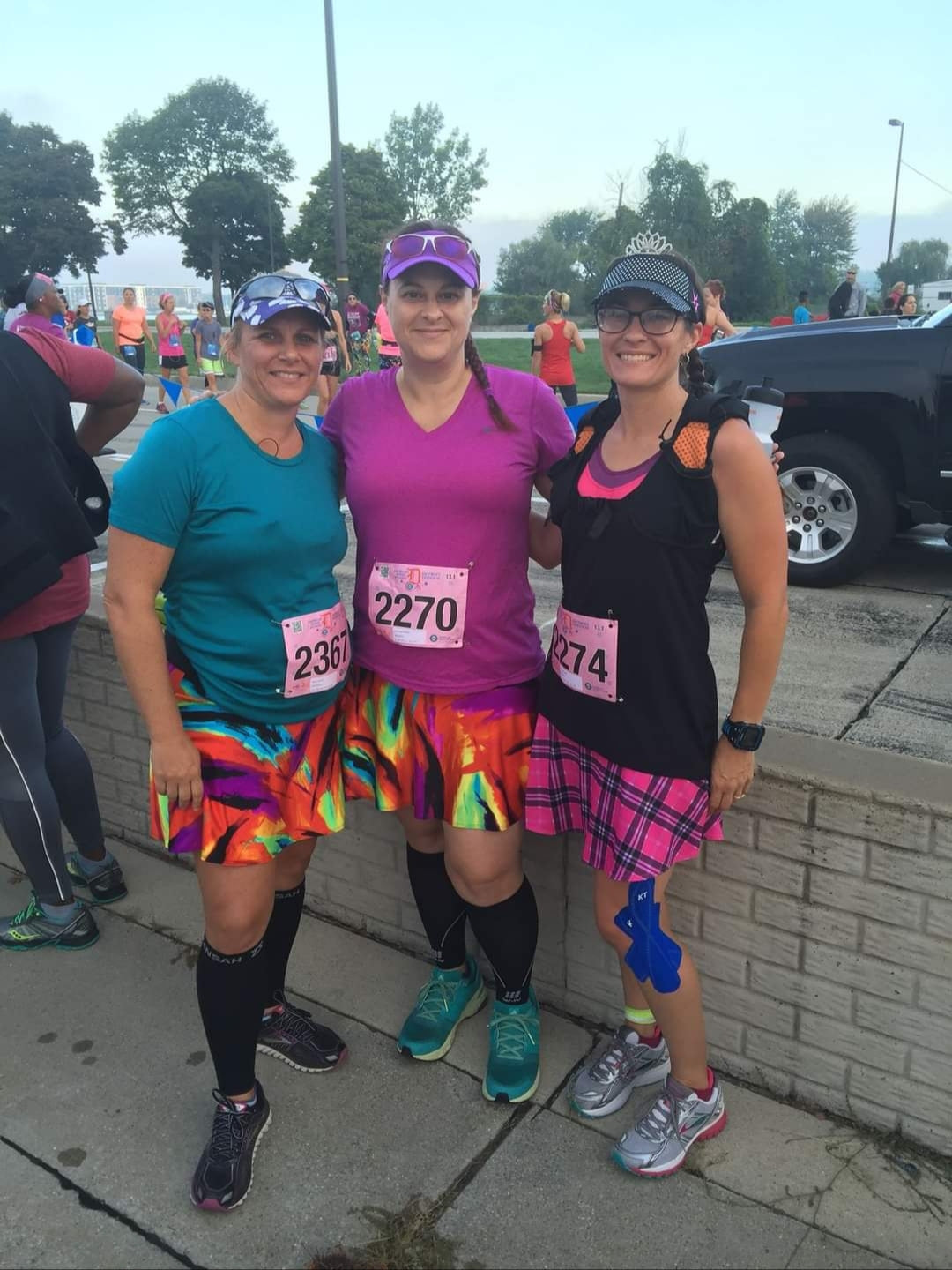 Melissa Marowelli posing at a race with friends wearing Bolder Athletic Wear skirts