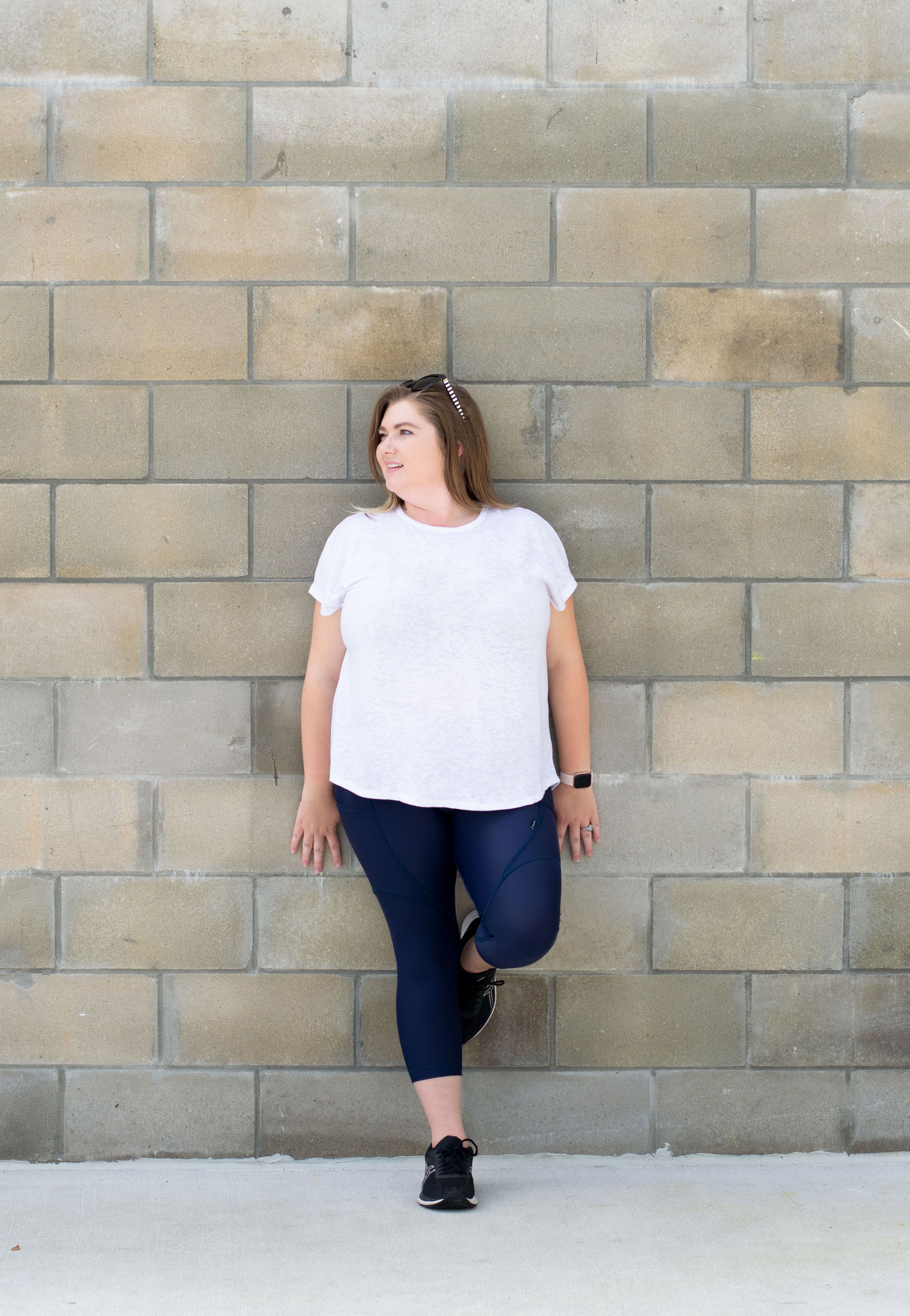 Navy leggings with model leaning against wall