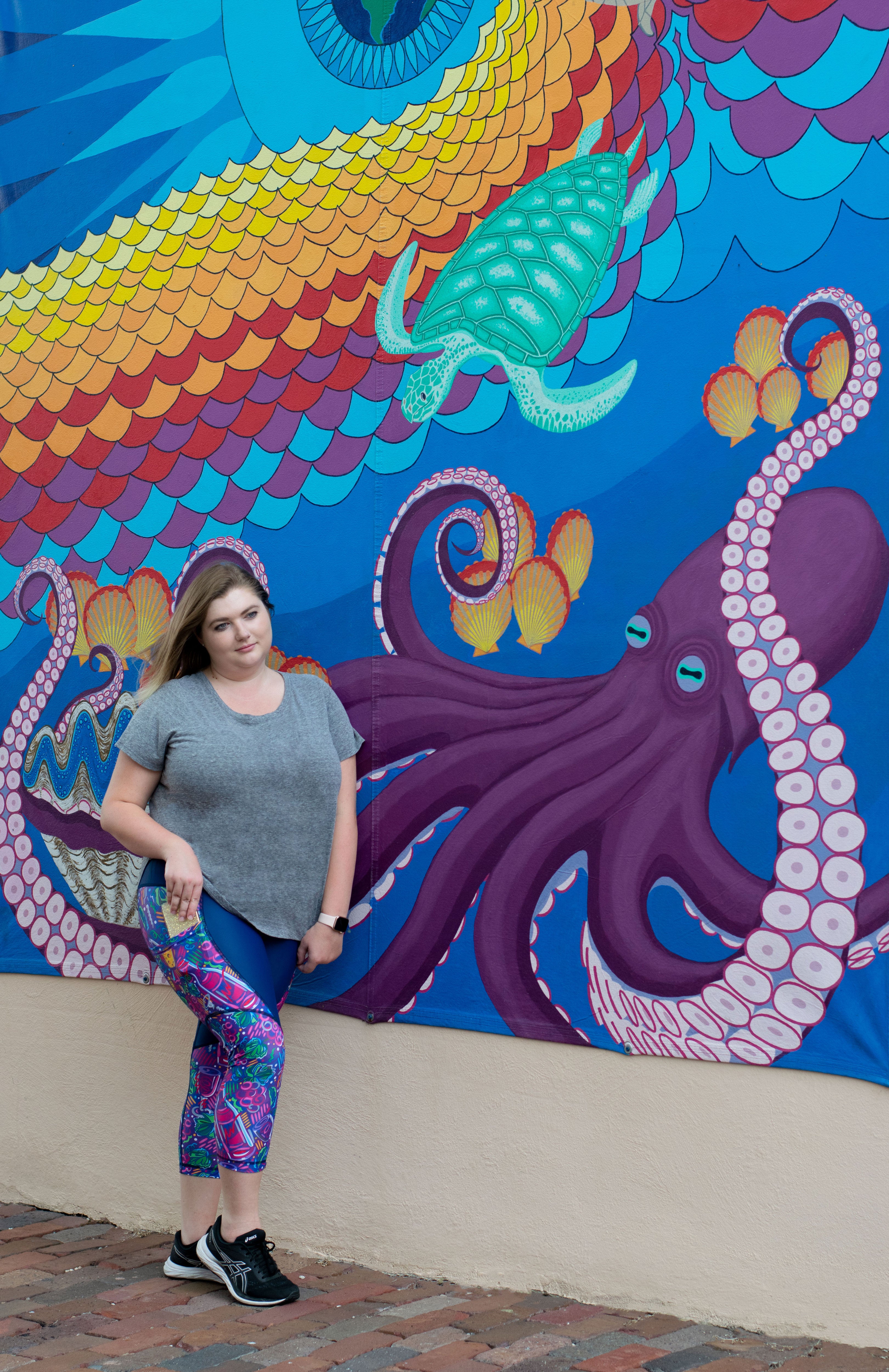 Model in front of wall art wearing Wine Me Up capris