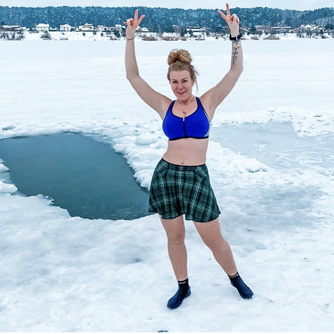 Samantha posing in front of an ice hole wearing a Bolder skirt