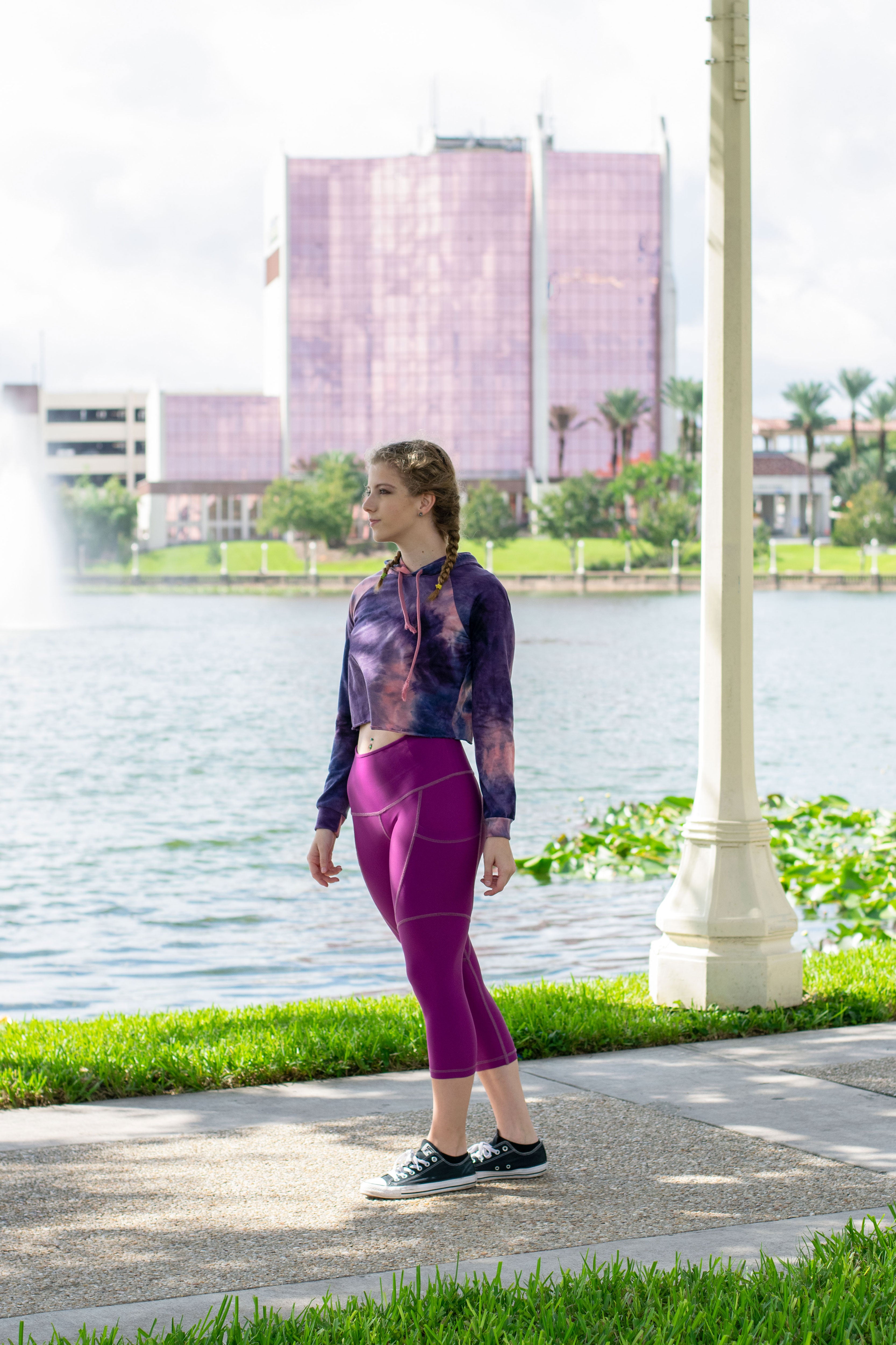 Model walking in merlot capris