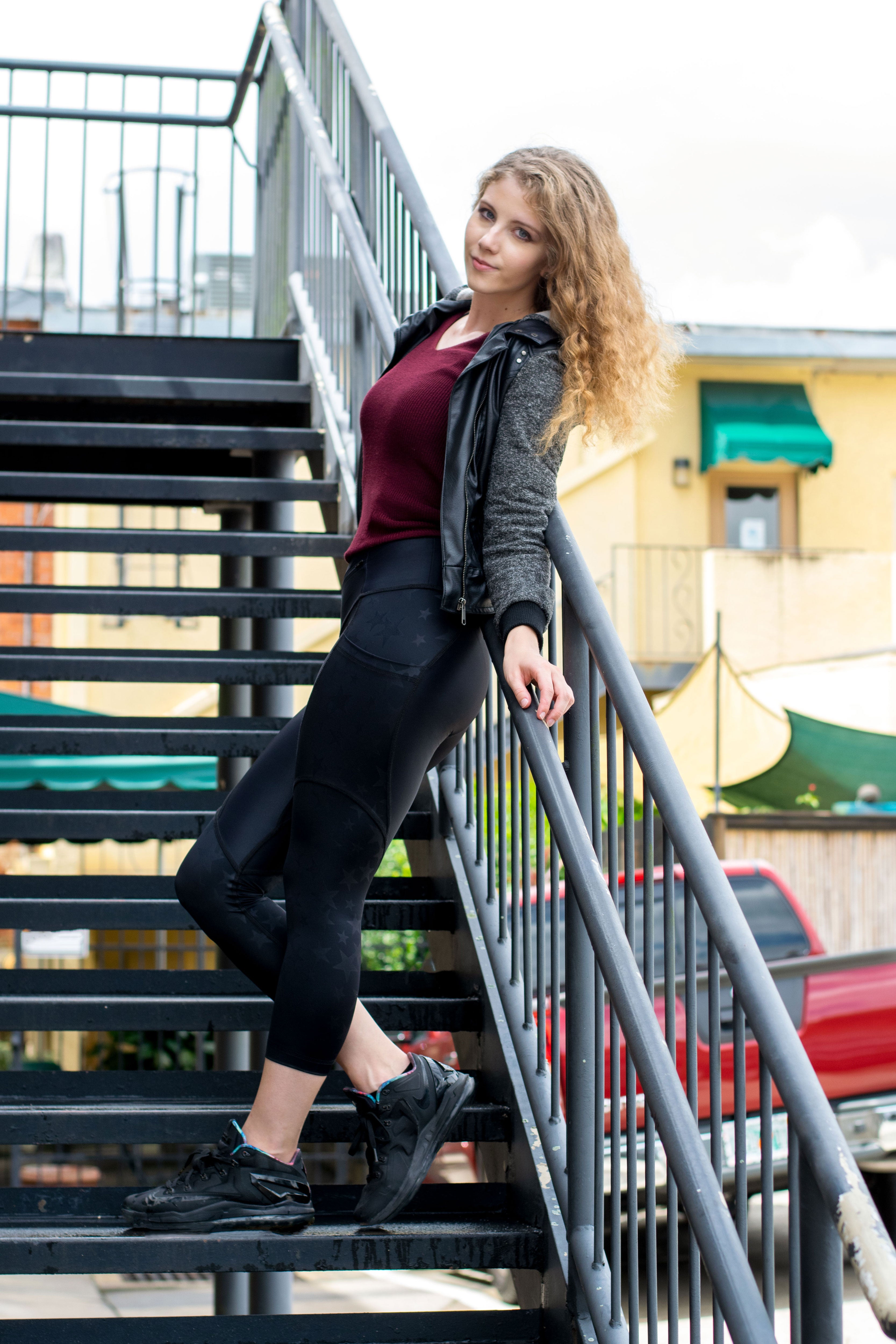 Model leaning on staircase wearing Starzon capris