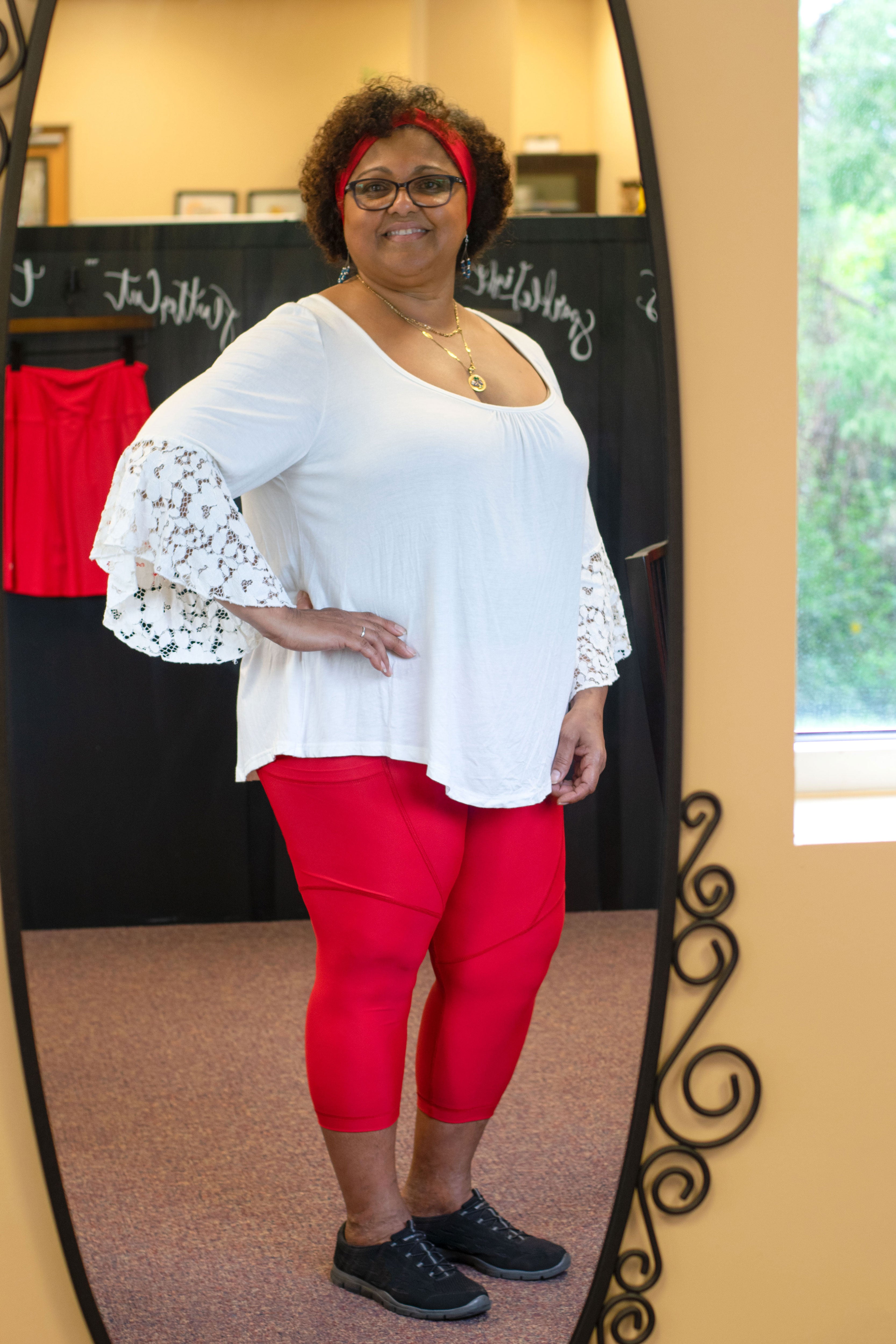 Model looking in mirror wearing red capris