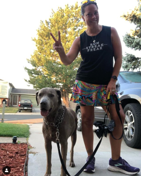 Woman wearing a Bolder skirt posing with her dog