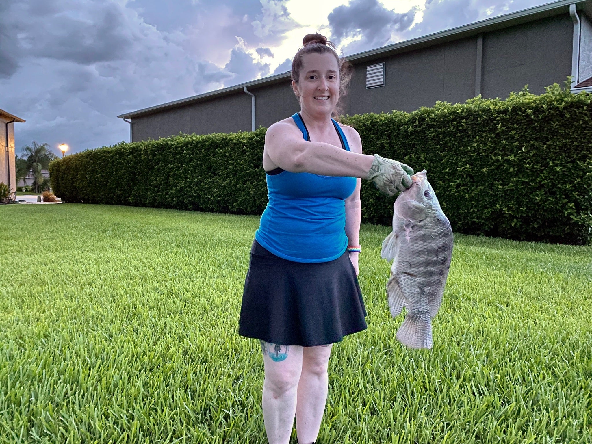 Becky holding a fish wearing a Bolder skirt
