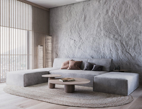 Round tables, corner sofa - all against a textured wall 