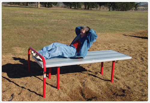 Kid doing sit-ups on a playground sit-up platform