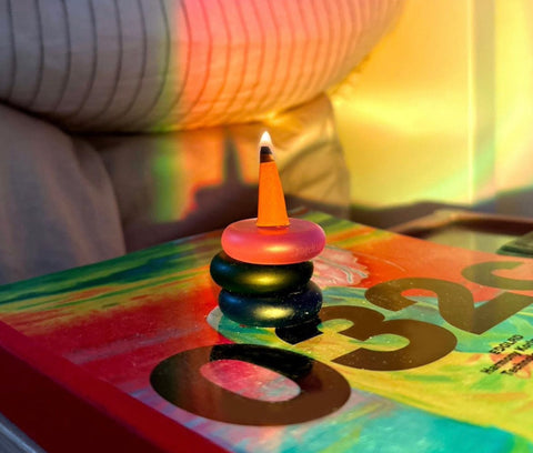 ripple+ incense cones lit on a bedside table for self-care and aromatherapy.