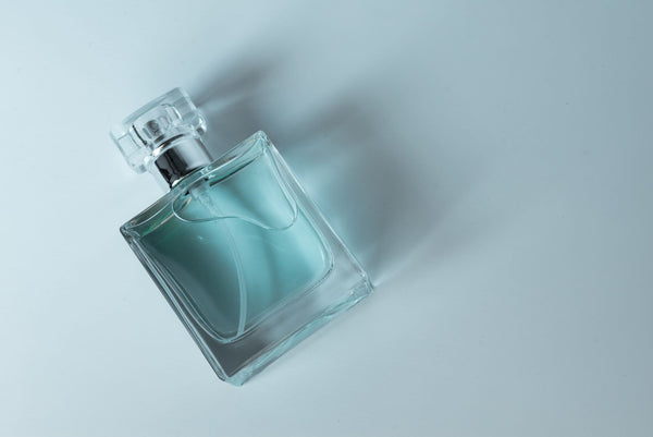 glass perfume bottle on a blue background