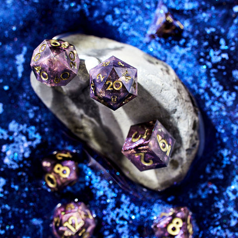 Purple set of d&d dice with gold numbering on a blue background