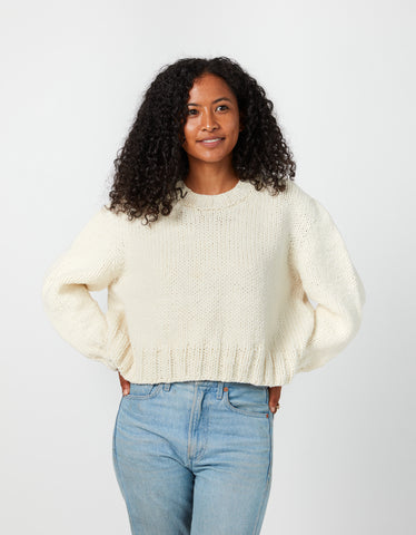 model is wearing a ivory-colored, handknit, pullover sweater