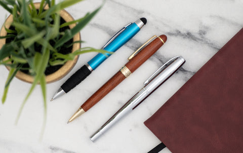 ballpoint pens with plastic, wood, and metal finishes