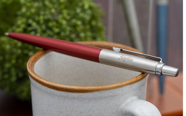 Red Parker Jotter engraved pen resting on mug