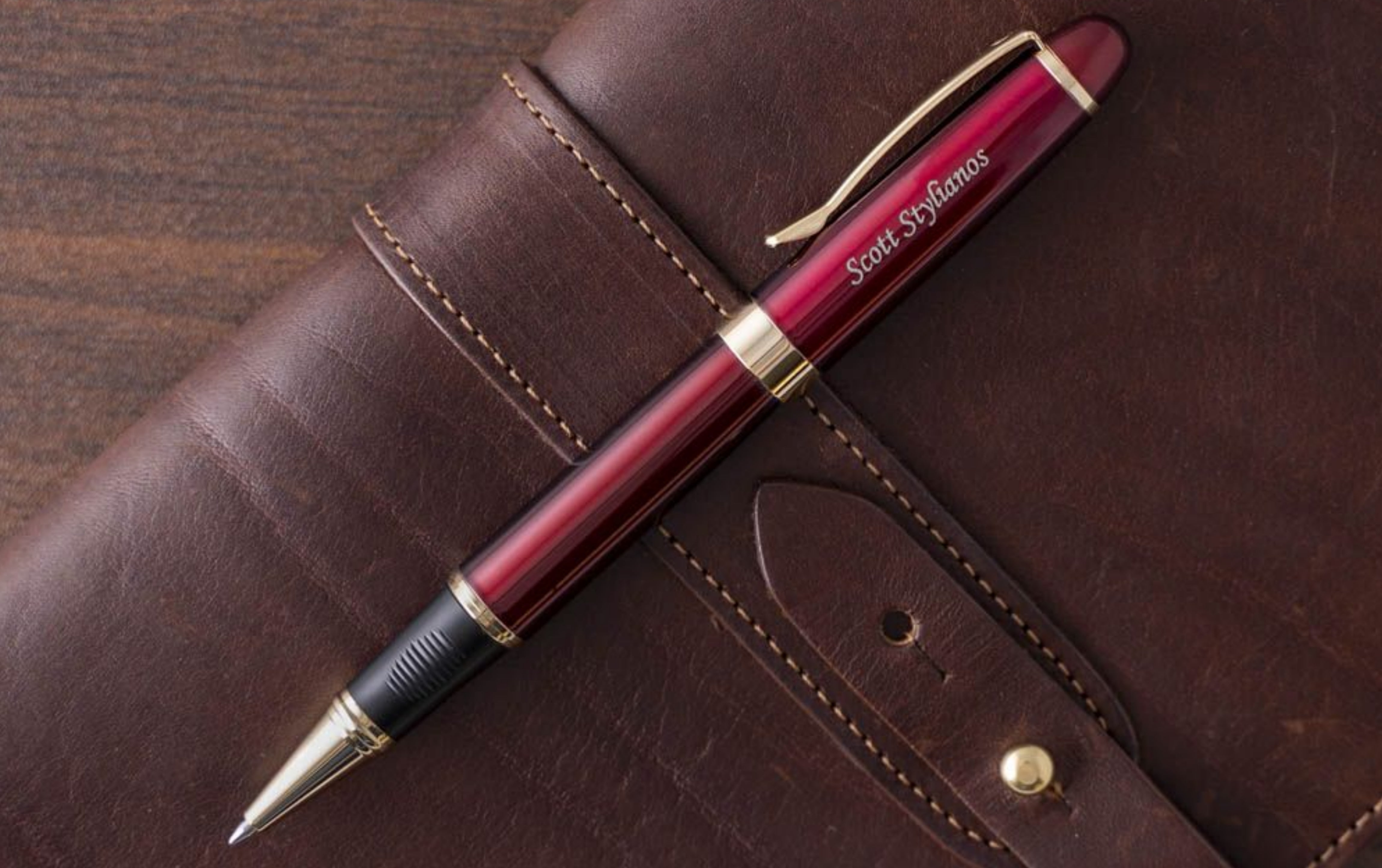 pen placed on leather bound journal