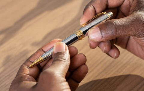 man holding engraved Bailey Medalist Ballpoint pen with engraving
