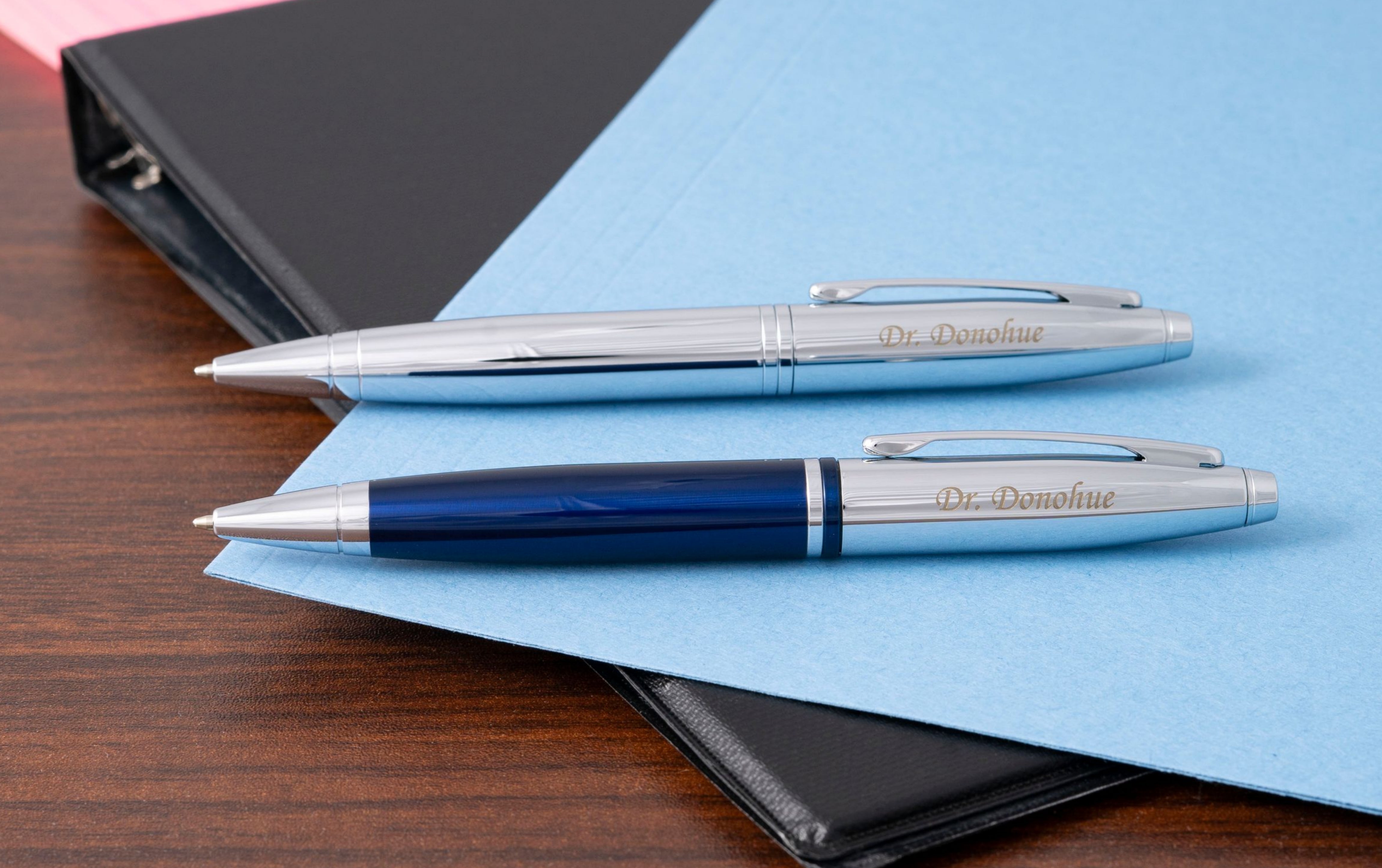 Engraved Calais Blue and Chrome Ballpoint Set on top of binder