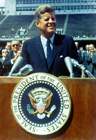 John F Kennedy standing a speech podium