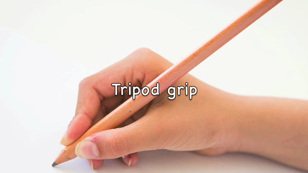 Hand holding a yellow pencil in a tripod grip