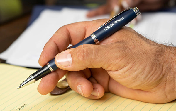 Parker IM blue and chrome rollerball pen in man's hand