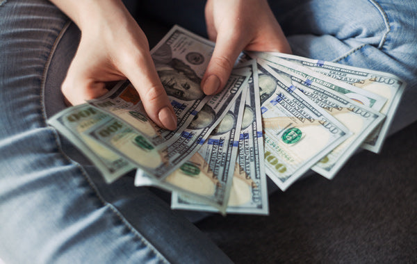 Girl holding American Dollar Bills