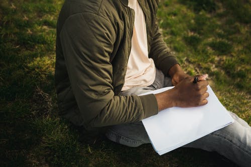 Crop artist with new sketchpad in park