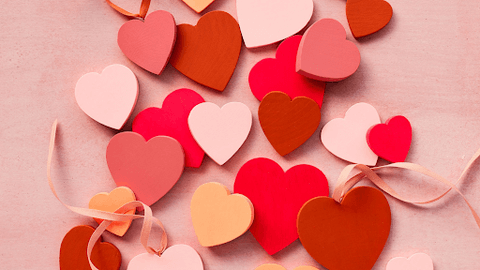paper cut hearts in different shades of red and pink