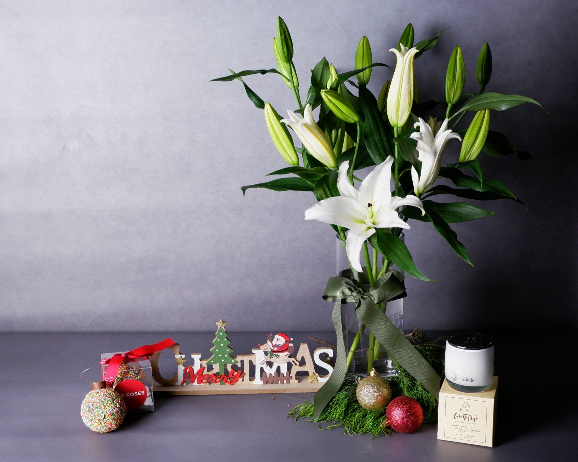 Image of Christmas Flowers - Lilies, Chocolate Bauble & Scented Candle Bundle