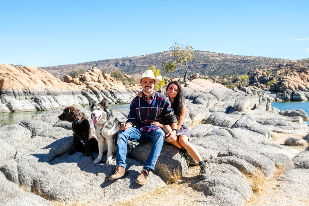 Arizona family camping between the boulders with dogs huskie and a lab