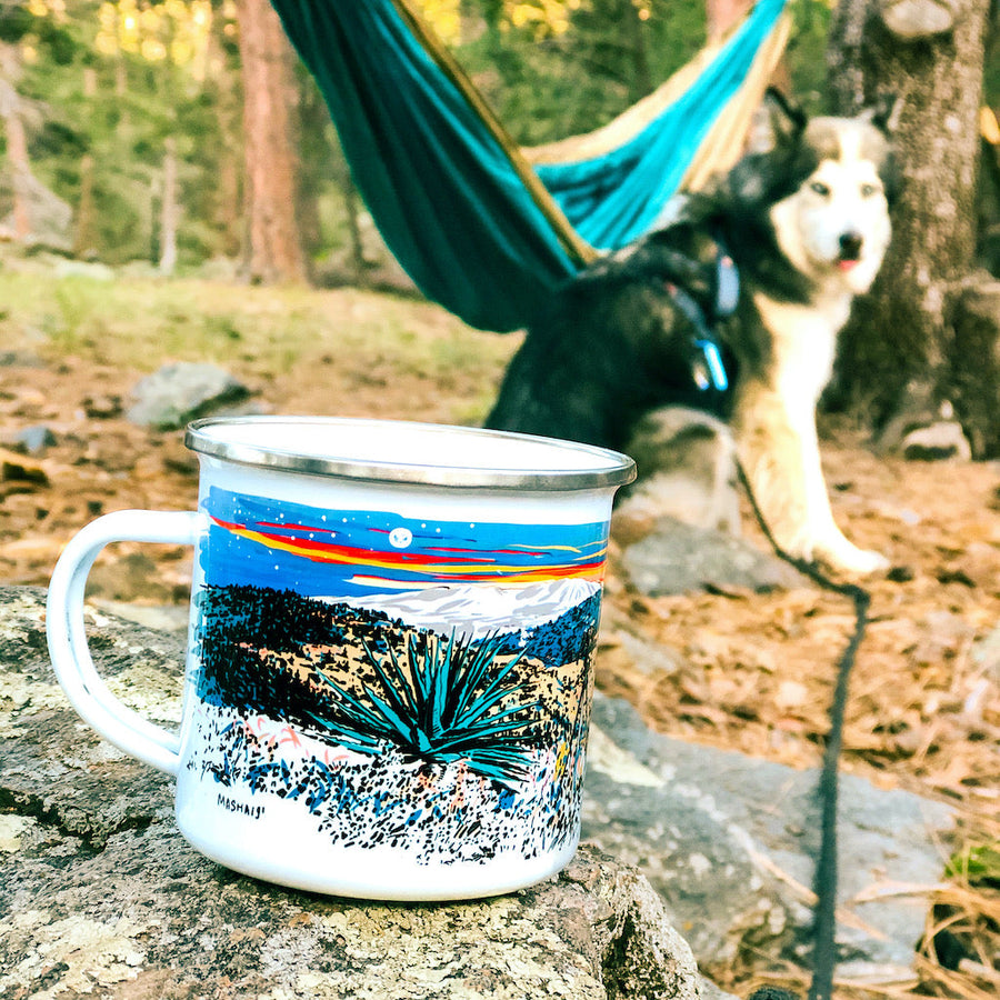 Unique coffee mug at a campsite with a hamock and a cute husky dog in the background