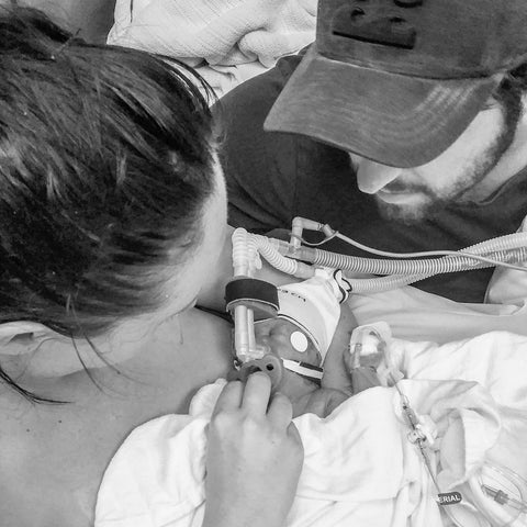 Mum cuddles premature baby in NICU while Dad watches over