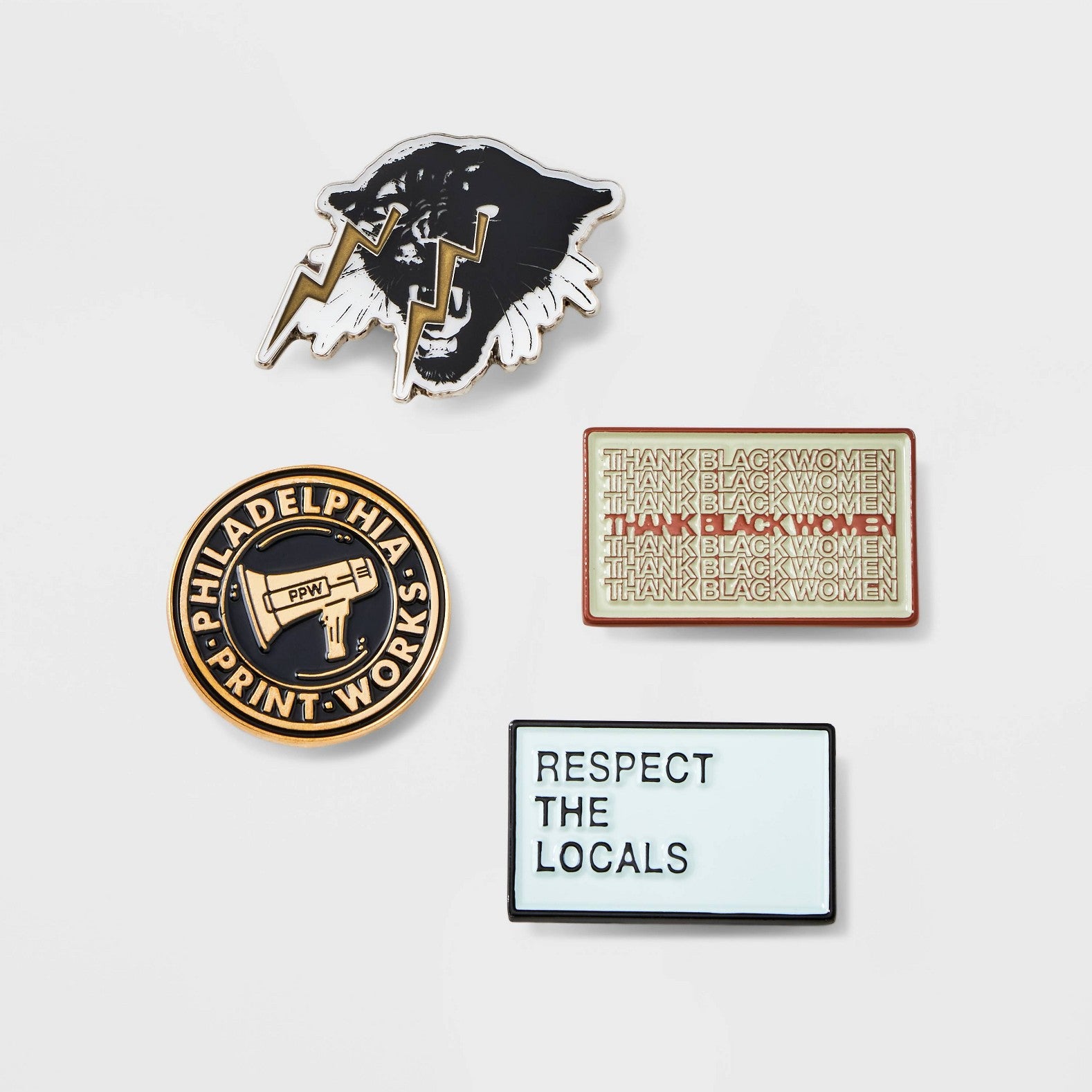 a set of four lapel pins: panther with lightning bolts, ppw logo, thank black women, and respect the locals