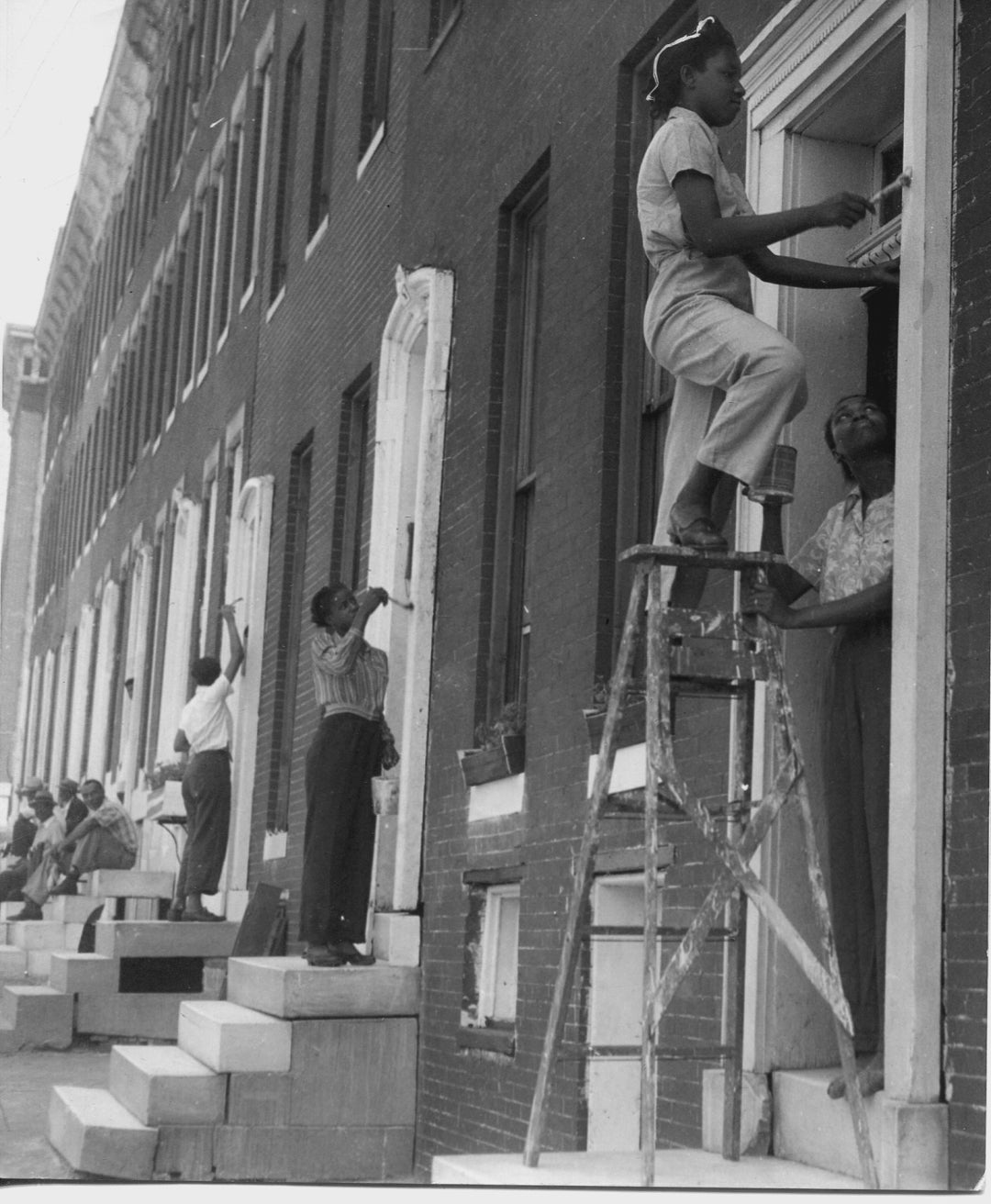 Vintage photo of people cleaning a neighborhood block